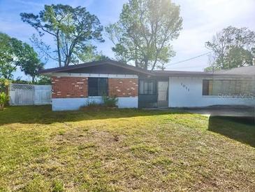 Modest single story home featuring a brick facade and a well-maintained lawn at 1011 Beulah Dr, Edgewater, FL 32132