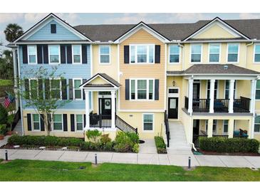 Charming townhouses featuring colorful exteriors, black shutters, and manicured landscaping for curb appeal at 1011 Cedar Bay Ln, Winter Springs, FL 32708