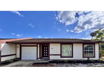 Charming single-story home with white siding, brown trim, and a well-maintained front yard at 1232 Roma Ct, Orlando, FL 32825