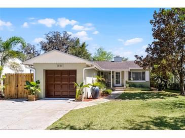 Charming one-story home with a well-manicured lawn, a driveway, and an attached garage at 1564 Cavendish Rd, Winter Park, FL 32789