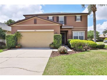 Charming two-story home featuring a well-manicured lawn, beautiful landscaping and attached two-car garage at 1750 Morning Sky Dr, Winter Garden, FL 34787