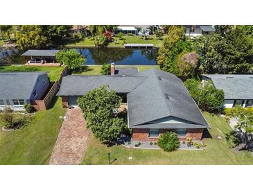 Aerial view of a single-Gathering home with well-kept landscaping and a waterfront view at 2601 Windward Ct, Orlando, FL 32805