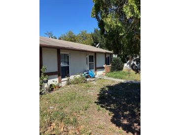 Modest single-story home featuring a simple facade and a small front yard under a blue sky at 2618 Adela Ave, Orlando, FL 32826