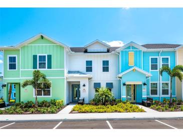 Colorful townhomes featuring unique designs and well-maintained landscaping offer a vibrant community atmosphere at 3192 Caribbean Soul Dr, Kissimmee, FL 34747