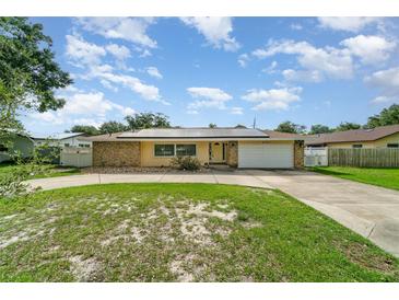 Charming ranch style home with stone accents, solar panels and a well manicured circular driveway at 690 S Lakemont Ave, Winter Park, FL 32792