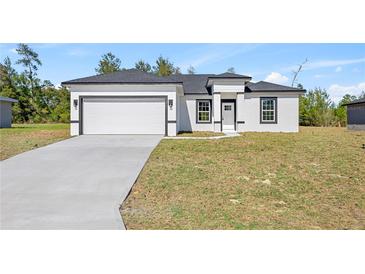 Charming single-story home featuring a two-car garage, neutral color palette and well-maintained landscaping at 16745 Sw 29Th Terrace, Ocala, FL 34473