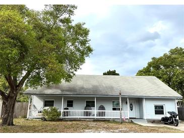 Charming single-story home featuring a welcoming front porch and mature trees providing ample shade at 191 Caldwell St, Apopka, FL 32712