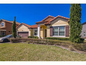 Charming one-story home featuring a red tile roof, lush landscaping, and a well-maintained front yard at 212 Lugano Way, Debary, FL 32713