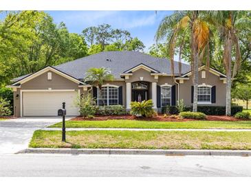 Charming single-story home with a well-manicured lawn and inviting front entrance at 640 Brookfield Pl, Apopka, FL 32712