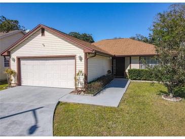 Charming single-Gathering home with a well-maintained lawn and an attached two-car garage at 6559 Grosvenor Ln, Orlando, FL 32835