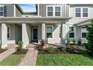 Charming front porch with brick pathway and landscaped garden at 13536 Autumn Harvest Ave, Winter Garden, FL 34787