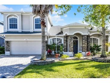 Charming two-story home featuring a landscaped yard and stone accents at 13722 Fox Glove St, Winter Garden, FL 34787
