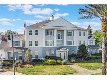 Beautiful building featuring distinct architectural style, well-maintained landscaping, and a welcoming entrance at 1598 Heritage Crossing Ct # 302, Reunion, FL 34747