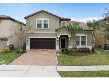 Charming two-story home featuring a well-maintained lawn and a two-car garage on a sunny day at 1639 Lima W Ave, Kissimmee, FL 34747