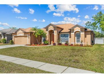 Charming home featuring desert landscaping and a two-car garage, set on a sunny day at 2721 Village Pine Ter, Orlando, FL 32833