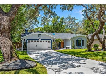 Charming single-story home featuring a spacious driveway and a well-manicured lawn at 878 W Timberland Trl, Altamonte Springs, FL 32714