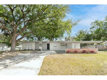 Charming single-story home featuring well-maintained landscaping, a covered carport, and a welcoming facade at 2417 Healy Dr, Orlando, FL 32818