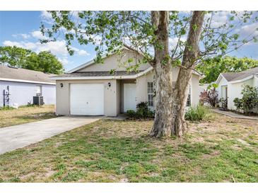 Charming single-story home featuring a one-car garage and a well-maintained front yard at 7435 Groveoak Dr, Orlando, FL 32810