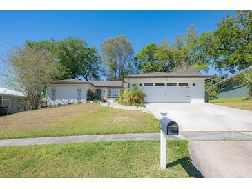 Charming single-story home featuring a two-car garage, well-maintained lawn, and inviting curb appeal at 769 Little Wekiva Cir, Altamonte Springs, FL 32714