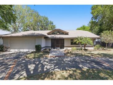 Charming single-story home with a two-car garage, front lawn, and inviting front door under blue skies at 9900 W Lake Marion Rd, Haines City, FL 33844