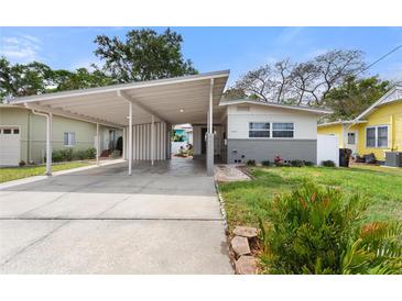 Charming single-Gathering home with a covered carport, lush landscaping, and a well-maintained front yard at 1500 Pinecrest Pl, Orlando, FL 32803