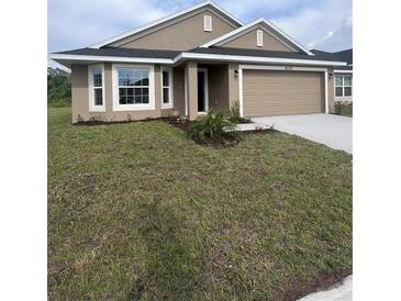 Charming single-story home featuring a bay window, neutral stucco exterior, and attached two-car garage at 4236 Sagefield Dr., St Cloud, FL 34773
