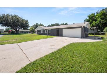 Charming home featuring a long driveway, well-maintained lawn, and an attached two-car garage at 5134 Harvard W St, Lakeland, FL 33810