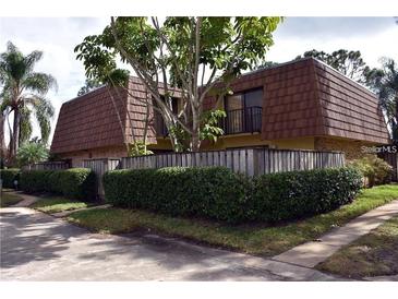 Charming two-story condo features mature landscaping and a private balcony at 5334 Bamboo Ct # 463, Orlando, FL 32811