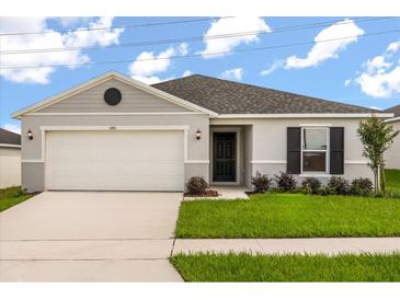 Charming single-story home featuring a two-car garage, well-maintained lawn, and classic curb appeal at 640 Royal Palm Dr, Dundee, FL 33838