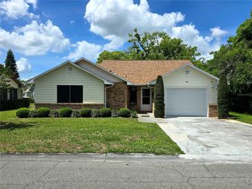Charming single-story home features a well-manicured lawn, lush landscaping, and a convenient one-car garage at 1016 Monroe Ave, St Cloud, FL 34769