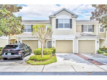 Charming townhome with a well-manicured lawn and attached garages in a desirable neighborhood at 1541 Florentino Ln, Winter Park, FL 32792