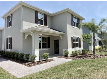 Charming two-story home showcasing a covered porch and well-manicured landscaping at 3024 Meleto Blvd, New Smyrna Beach, FL 32168