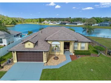 Inviting single Gathering home featuring lush green lawn and beautiful water view at 4229 Settlers Ct, St Cloud, FL 34772