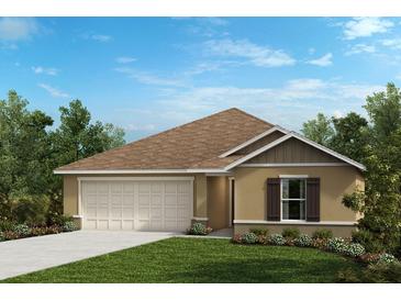 Charming one-story home featuring a neutral color scheme, a two-car garage, and tidy landscaping at 576 Mahogany Way, Dundee, FL 33838