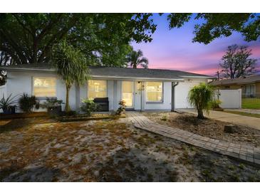 Charming single-story home with a well-manicured front yard and a brick pathway leading to the front door at 80 Lombardy Rd, Winter Springs, FL 32708