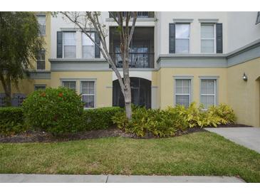 Inviting facade with manicured landscaping, a covered entrance, and charming architectural details at 8180 Boat Hook Loop # 105, Windermere, FL 34786