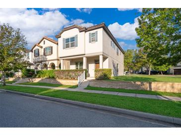 Attractive two-story home with a well-kept lawn and manicured shrubs in a lovely neighborhood at 9330 Meadow Hunt Way, Winter Garden, FL 34787