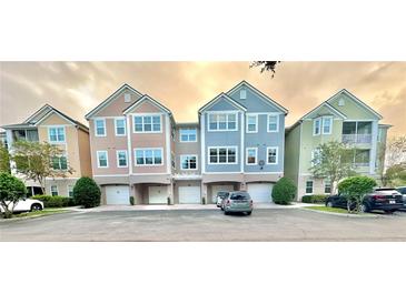 Charming townhome complex with colorful facades and attached garages in a desirable community at 3344 Corona Village Way # B4, Orlando, FL 32835