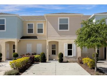 Inviting townhouse with tidy front landscaping and concrete driveway, perfect for easy living at 4730 Coral Castle Dr, Kissimmee, FL 34746