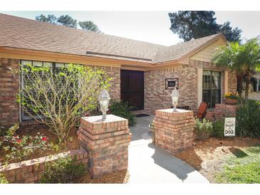 Inviting entrance with brick pillars, walkway, and landscaping, adding to the home's character at 1157 Duncan Dr, Winter Springs, FL 32708