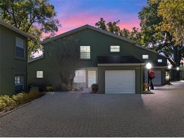 Charming townhome with an attached garage and ample parking on a brick paved drive at 128 Waverly Pl # 128, Orlando, FL 32806