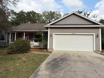 Charming single-story home with a two-car garage and well-maintained front yard at 13018 S Sunset Ter, Winter Garden, FL 34787