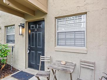 Inviting front entrance with a dark door and an outdoor seating area at 2507 E Central Blvd # 21, Orlando, FL 32803