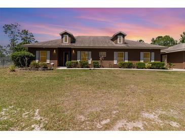 Charming single-story home with well-maintained landscaping and a spacious front lawn at 5242 Bancroft Blvd, Orlando, FL 32833