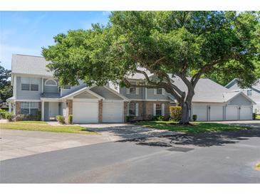 Charming townhome featuring a well-maintained exterior and mature trees, showcasing a welcoming curb appeal at 5258 Tunbridge Wells Ln # 4, Orlando, FL 32812