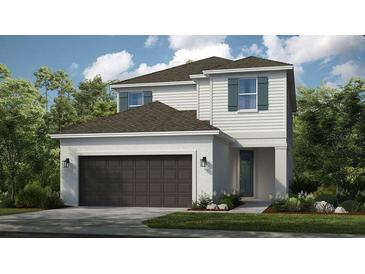 Charming two-story home with a two-car garage, neutral paint, and an inviting front entrance at 5646 Ficus Aurea St, Kissimmee, FL 34758