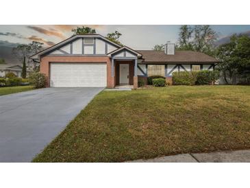 Charming single Gathering home showcasing brick accents, a well manicured lawn and a two car garage at 7602 Glenmoor Ln, Winter Park, FL 32792