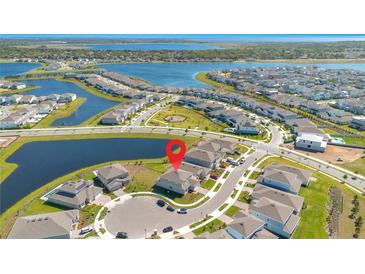 Stunning aerial view of a lakeside community highlighting the property's prime location near the water at 13231 Panama Beach Ct, Orlando, FL 32827