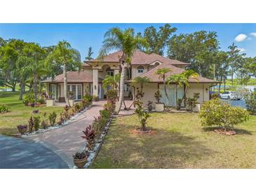 Stunning two-story home featuring meticulous landscaping and a circular driveway at 2910 Frontier Dr, Kissimmee, FL 34744