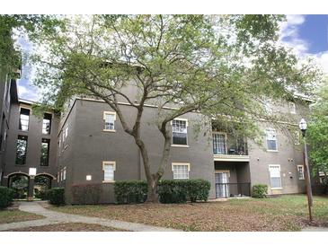 Attractive multi-Gathering building with neutral paint, trimmed windows, lawn area, and mature shade tree at 1321 Arbor Vista Loop # 325, Lake Mary, FL 32746